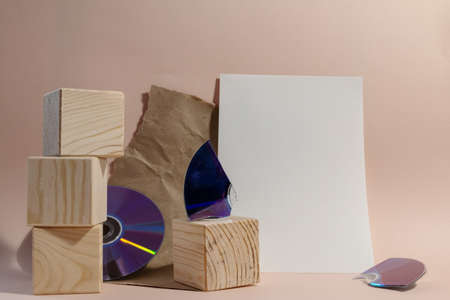 still life of wooden cubes, broken disc and torn paper with empty spaceの写真素材