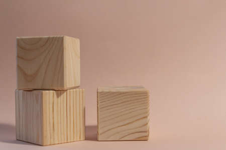 wooden cubes still life against pale pink backgroundの写真素材