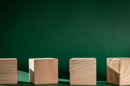 wooden cubes still life against emerald green backgroundの写真素材