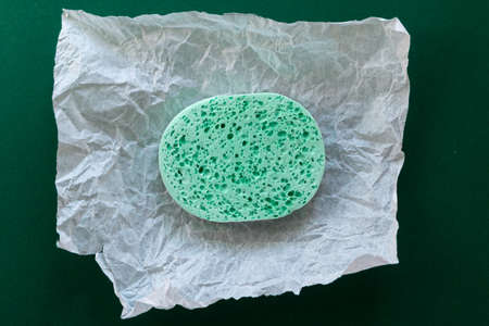 face cleaning sponge top view with crumpled packaging paperの写真素材