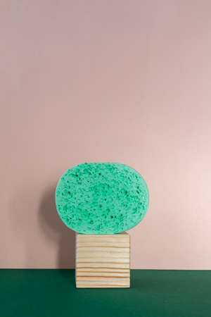 face cleaning sponge on a wooden cube, balancing still life retro styled