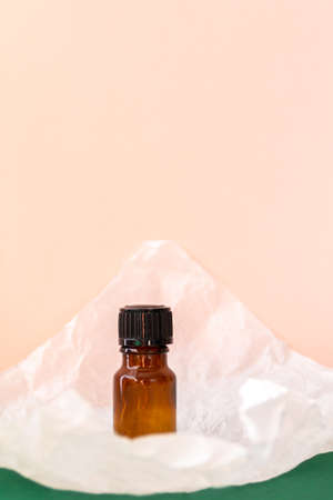 Aroma oil glass bottle with torn paper, skin care productsの写真素材