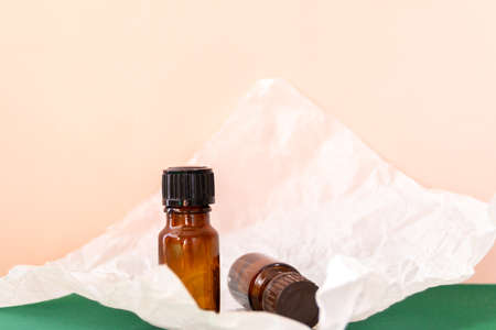Aroma oil glass bottle with torn paper, skin care productsの写真素材