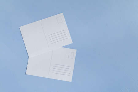 Empty greeting postcard against light blue backgroundの写真素材