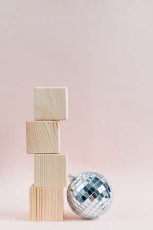 wooden cubes against pink background, empty space for text