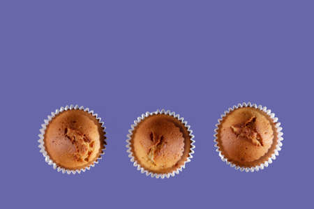 cupcakes flat lay view against purple backgroundの写真素材