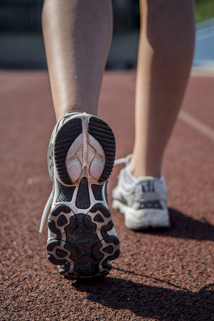 young woman goes in for sports at gymの写真素材