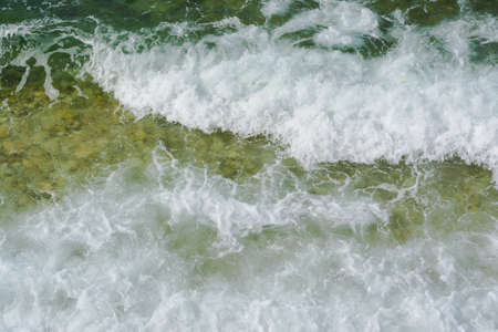Beautiful background of liquid sea waves with foam