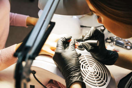 Arseniev, Russia-November 16, 2019. Close-up of professional hands of a manicure masterのeditorial素材