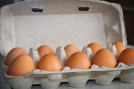 Full tray with chicken eggs. Eggs cardboard container. Close-up. Selective focus