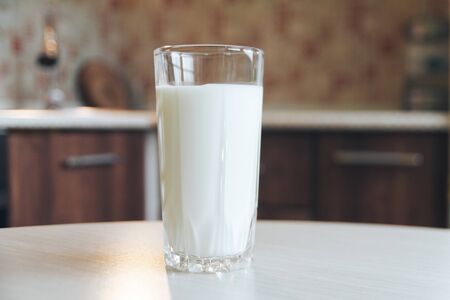 Glass of milk. Pouring milk in a transparent glassの写真素材