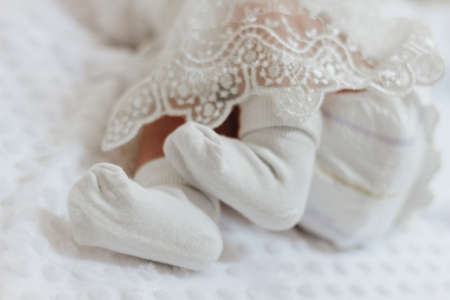 Close-up of the baby's legs in white socks. Happy childhood childhood. Backgroundの写真素材