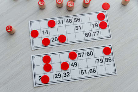 Traditional Russian board game Russian Lotto. Cards with numbers, closeup. Wooden barrels with...