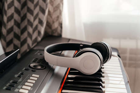 Headphones on musical synthesizer keyboard. Headphones on electronic pianoの写真素材