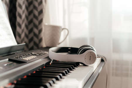 Headphones on musical synthesizer keyboard. Headphones on electronic pianoの写真素材