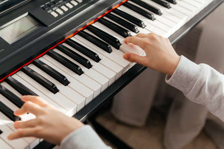 Close up hands of caucasian girl playing synthesizer.の写真素材