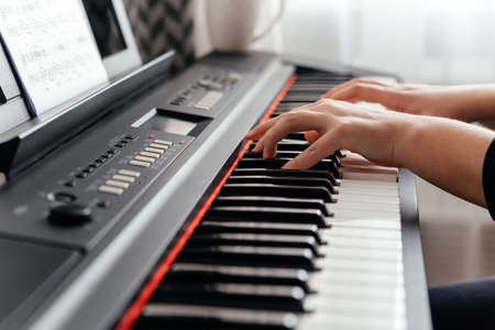 Close up hands of caucasian woman playing synthesizer.の写真素材