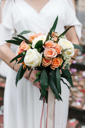 delicate wedding bouquet in the hands of the brideの写真素材