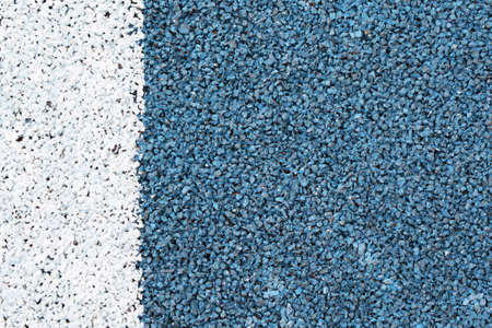Blue and white grainy texture. Road surface. White strip on a blue backgroundの写真素材