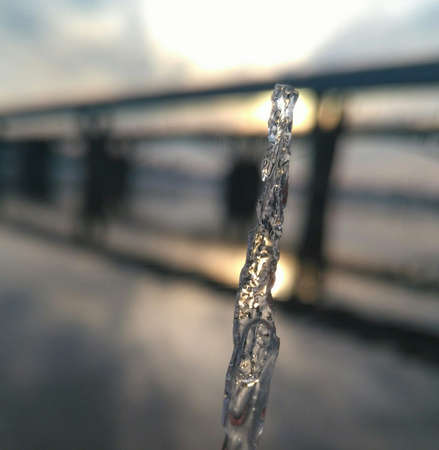 transparent elongated piece of ice illuminated by the sunの写真素材