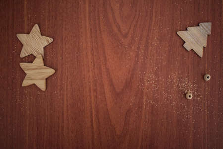 New Year's decoration. glowing garlands and wooden figurines on a wooden background. Place for textの写真素材