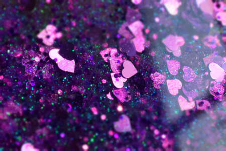 Lots of purple shiny sequins as background, close up