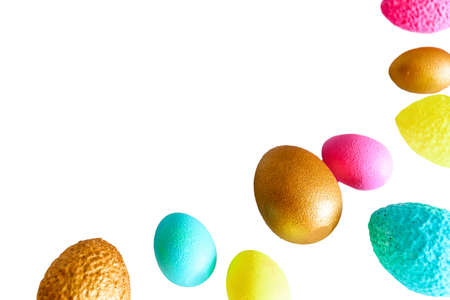 Pink, yellow, blue and gold Easter eggs on a white background. Copy space.の写真素材