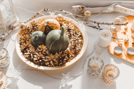 Pumpkins, cones and candles on the windowsill. Autumn decor.の写真素材