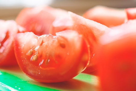 Tomato slices on a green background. Healthy food. Macro photo.の写真素材