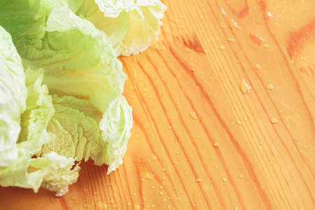 Peking cabbage leaves close-up. Healthy food. On a wooden table.の写真素材