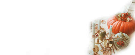 Pumpkins and candlesticks on a white background. Autumn banner. Copy space.の写真素材
