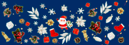 Santa Claus, snowflakes, berries, poinsettia and gifts on a blue background with bokeh. Christmas...