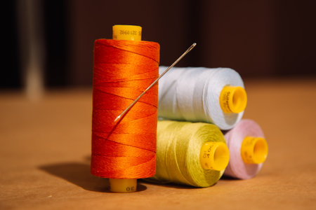Multicolored coils of sewing thread orange Green Blueの写真素材