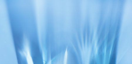 refraction of light from glass glare of light on a blue surfaceの写真素材