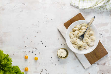 A bowl with meat dumplings on a white background