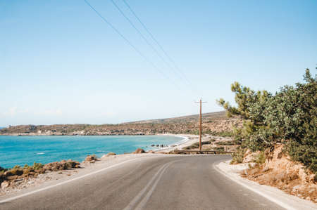 Landscape with road, hills and seashore.の写真素材