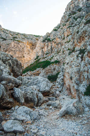 Rocky mountains in the gorge, Crete island, Greece. Daytime landscape on a sunny day.