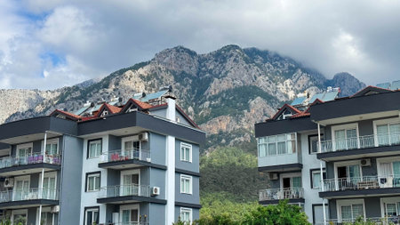 Landscape with multi-storey buildings against the backdrop of mountains, summer sunny day, cloudy, Turkey, Kemer.の写真素材