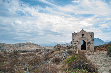 Ancient ruined stone abandoned building on top of a cliff. Summer Mediterranean landscape. Gramvousa, Crete island, Greece.の写真素材