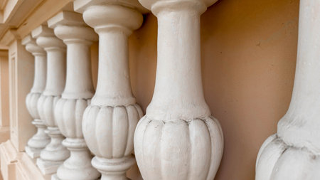 Close-up photo of elegant white balusters in a row, showcasing their classic architectural design...