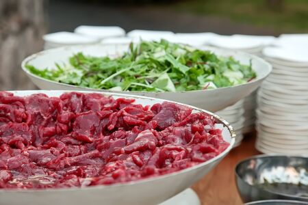 slices of raw fresh beef meat fillet in a ceramic dish の写真素材