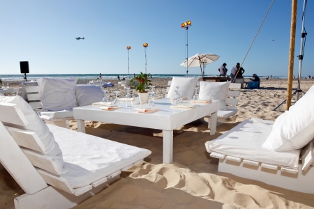 The tables are set for a romantic  wedding reception overlooking the beach and the deep blue sea のeditorial素材