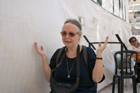 JERUSALEM, ISRAEL - MARCH 14, 2006  A woman prays at the Wailing Wall  The Western Wall, Wailing Wall or Kotel is located in the Old City of Jerusalem at the foot of the western side of the Temple Mount のeditorial素材