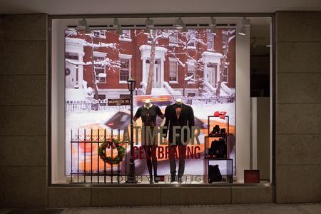 MUNICH, GERMANY - DECEMBER 25, 2009: Fashion store's shop window. Dressed man mannequins in a fashion store's shop window decorated for Christmas. Munich, Germany.のeditorial素材