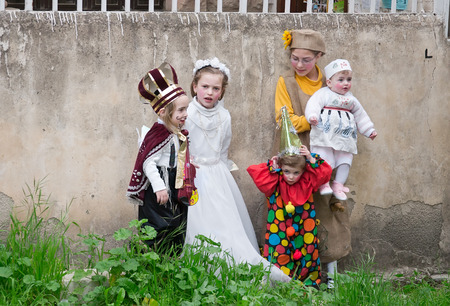 JERUSALEM, ISRAEL - MARCH 15, 2006: Purim carnival in the famous ultra-orthodox quarter of Jerusalem - Mea Shearim. Group portrait of five children dressed in carnival costumes. Purim is celebrated annually according to the Hebrew calendar. Purim is the cのeditorial素材