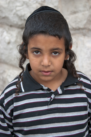 JERUSALEM, ISRAEL - MARCH 15, 2006: Purim carnival in the famous ultra-orthodox quarter of Jerusalem - Mea Shearim. Portrait of a boy children with a kippa on his head. Purim is celebrated annually according to the Hebrew calendar. Purim is the custom of のeditorial素材