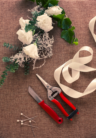 Florist workplace. Tools and accessories. Flowers, pruner, knife, pinsの写真素材