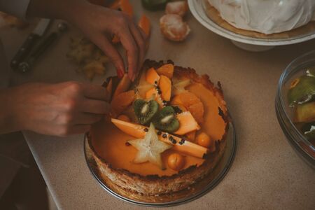 MakingÂ cake with fresh fruits dragon fruit papaya carambolaの写真素材