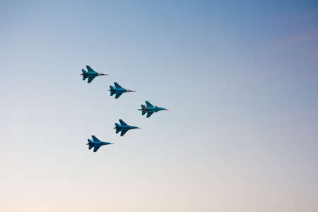 Jet fighters at the airshow moving upward in the sunset skyのeditorial素材