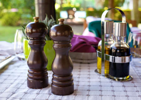 Salt and pepper mills on the tableの写真素材